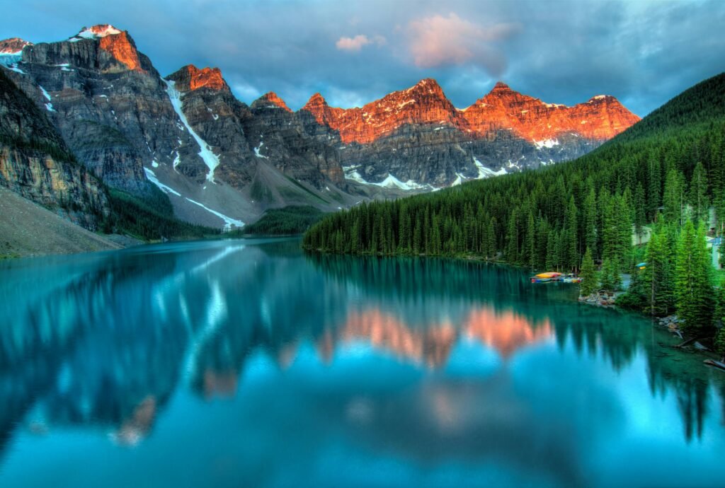 Capture the serene beauty of Moraine Lake with sunrise reflections in Banff National Park.