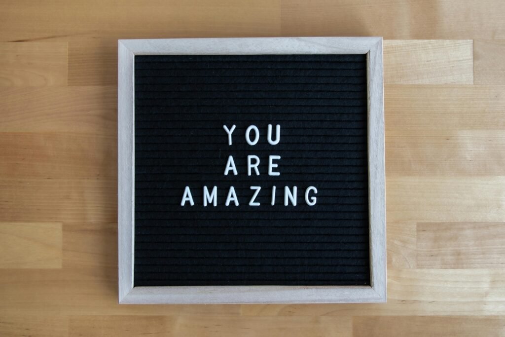 Letter board displaying 'You Are Amazing' on a wooden table, conveying motivation.