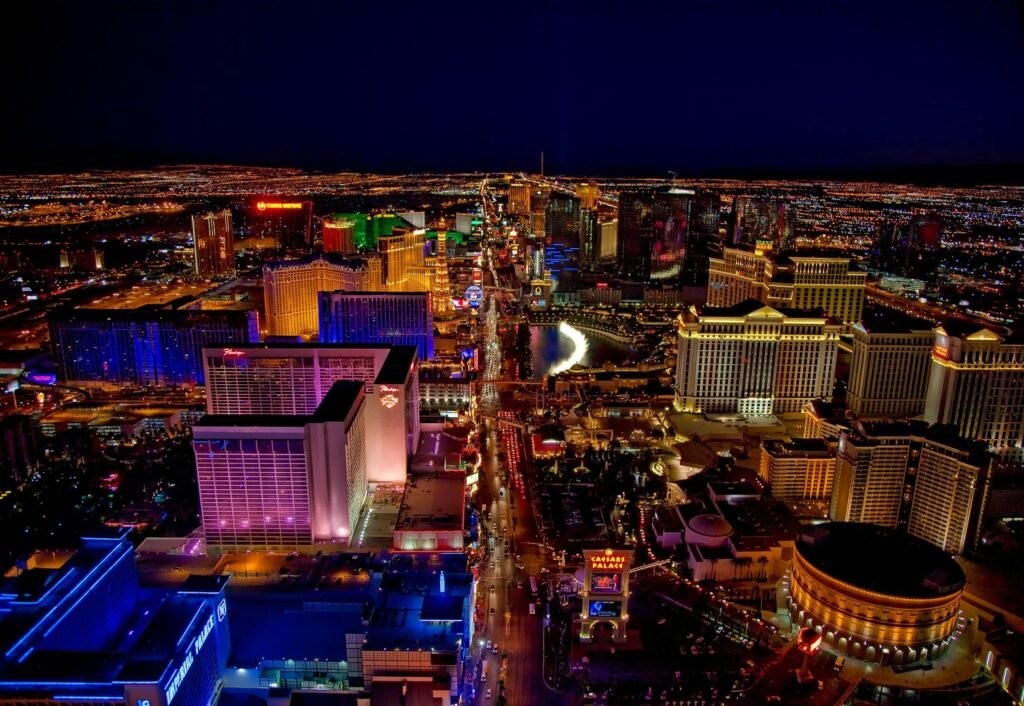 Stunning aerial view of Las Vegas Strip glowing at night with vibrant neon lights and bustling nightlife.