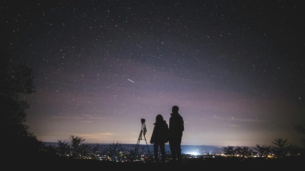 A couple stargazes under a starry sky in Elkton, VA, capturing the beautiful Milky Way.