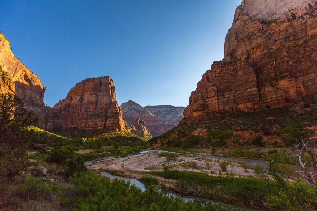 Scenic landscape of Zion National Park with towering canyons and a winding river.