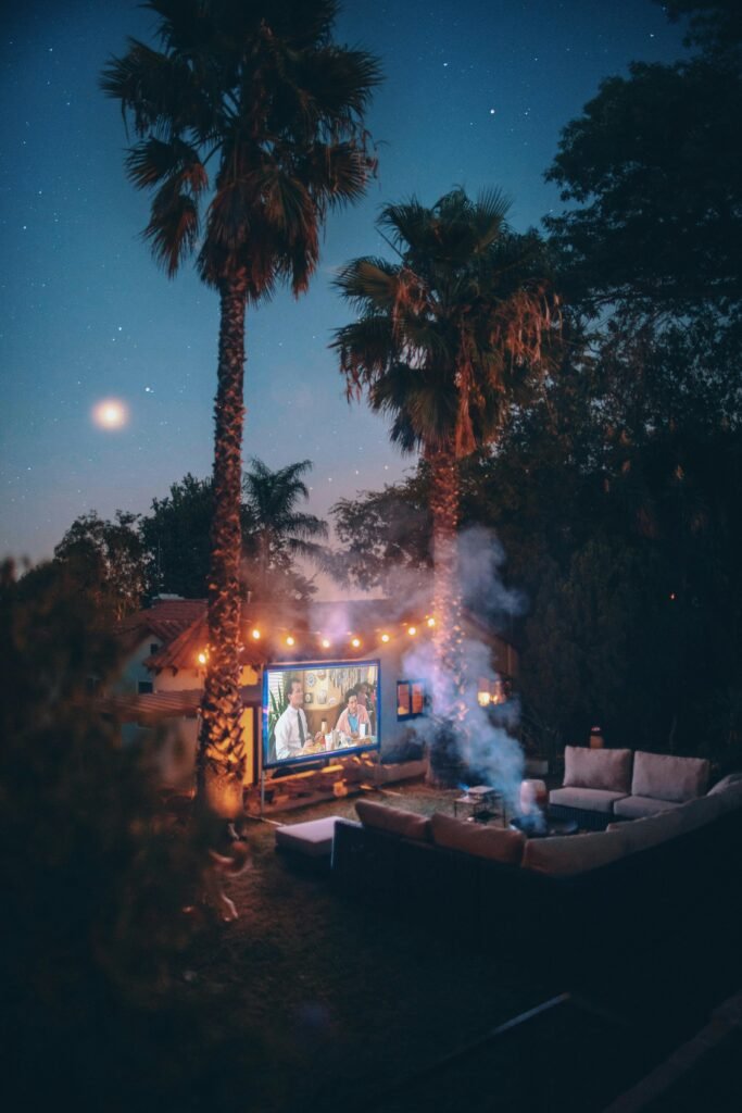 Relaxing outdoor movie night setup with projector under a starry sky in Los Angeles.