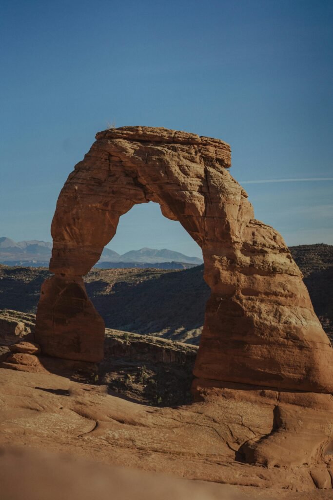 Delicate Arch stands majestic against a clear blue sky in the iconic Arches National Park.